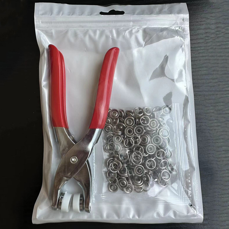 One pair of iron pliers +50 pairs of buttons [bagged]